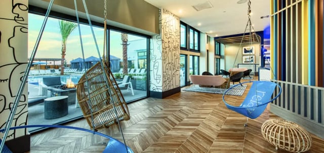 Hanging chairs sofas and pool view lounge at Canvas in Tempe Student Accommodation