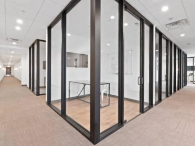 Glass partitioned study room with desk and chair hallway at UCity Flats in Philadelphia Student Accommodation