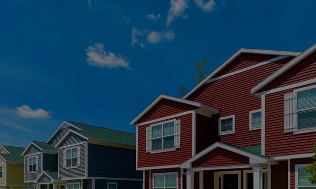 Row of colorful townhouses with white shutters exterior at Campus Creek Cottages in Big Rapids Student Accommodation