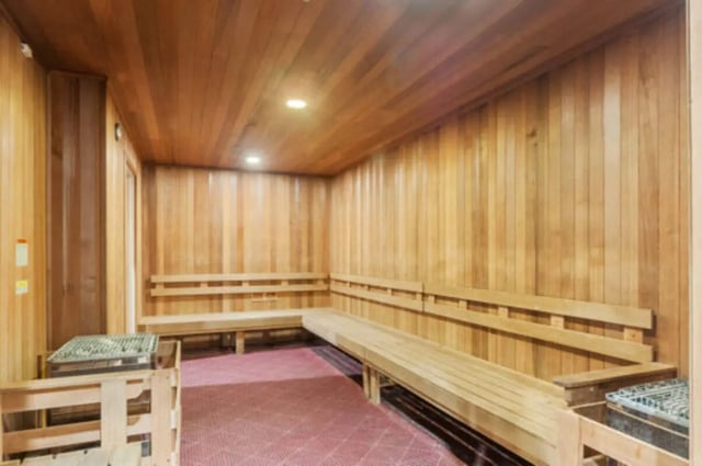 Wooden benches with heaters in a sauna room at Brexx at State College in State College Student Accommodation