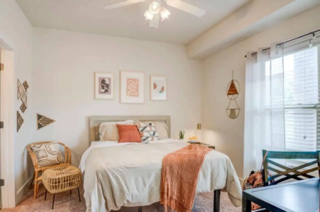 Bed rattan chair artwork and ceiling fan bedroom at Brexx at State College in State College Student Accommodation