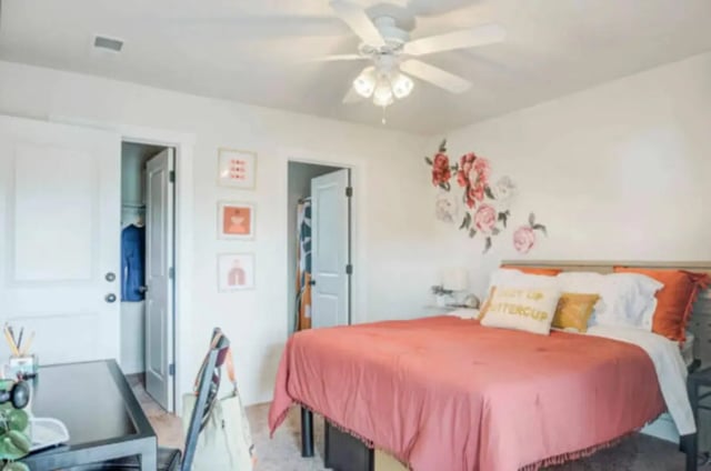 Bed with pink comforter floral wall art bedroom at Brexx at State College in State College Student Accommodation