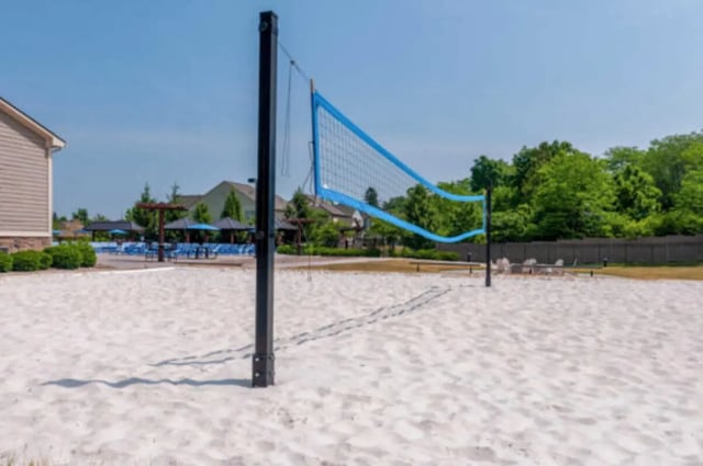 Volleyball court with blue net and sand Playing area at Brexx at State College in State College Student Accommodation
