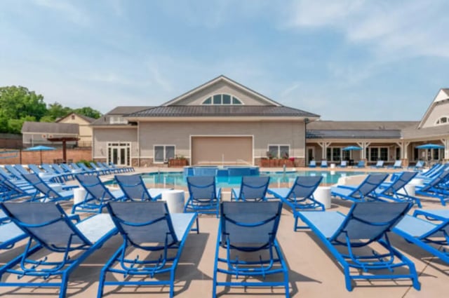 Blue lounge chairs beside swimming pool exterior at Brexx at State College in State College Student Accommodation