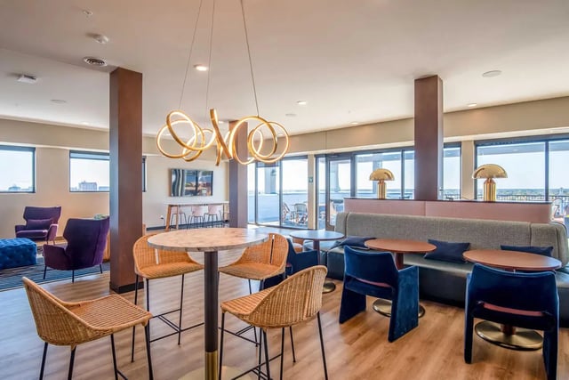 Modern lounge with marble table and wicker chairs living room at Ascend RVA in Richmond Student Accommodation