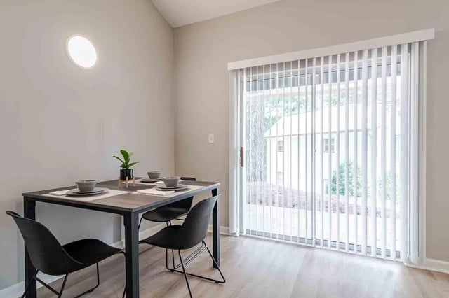 Table with chairs and plant dining area at The Townhomes At River Club in Athens Student Accommodation