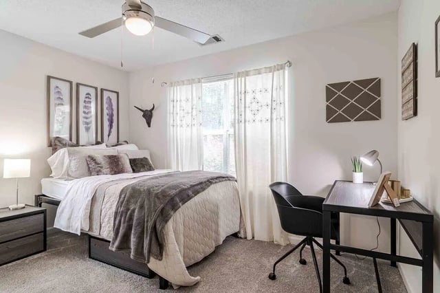 Bed desk lamp and chair bedroom at The Townhomes At River Club in Athens Student Accommodation