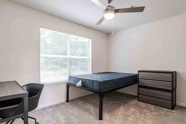 Bed desk chair and dresser bedroom at The Townhomes At River Club in Athens Student Accommodation
