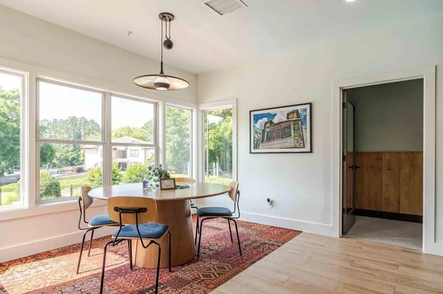 Round table four chairs patterned rug dining area at The Townhomes At River Club in Athens Student Accommodation