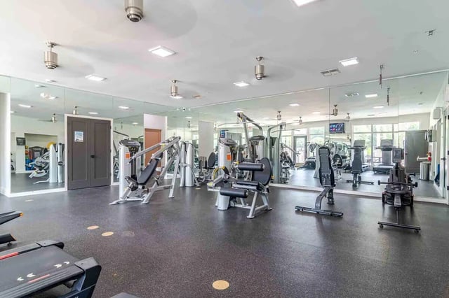 Gym equipment treadmills and weight machines fitness area at The Townhomes At River Club in Athens Student Accommodation