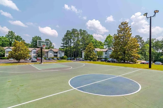 Basketball court with apartment buildings exterior at The Townhomes At River Club in Athens Student Accommodation