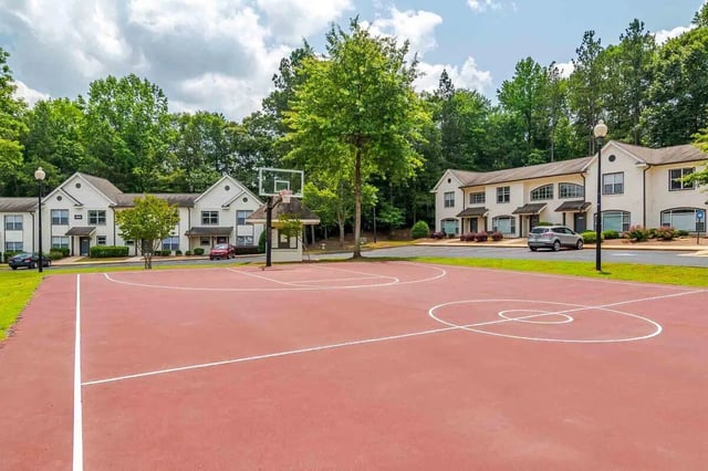 Apartment buildings with basketball court exterior at The Townhomes At River Club in Athens Student Accommodation