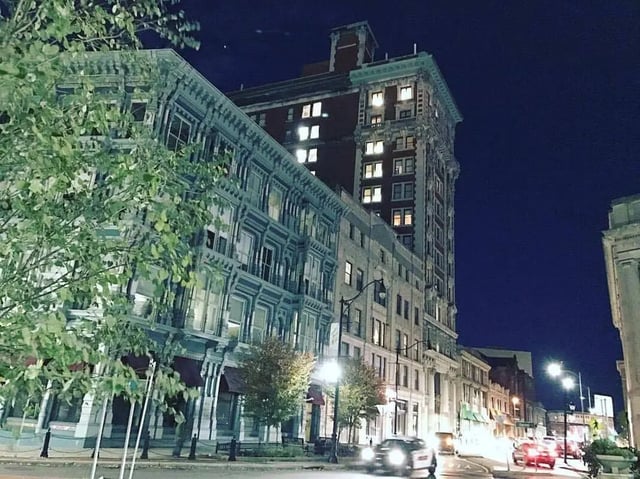 Buildings with lit windows and trees exterior at The Printing House in Binghamton Student Accommodation