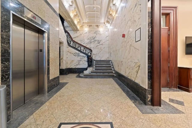 Elevator marble staircase and tiled floor interior at The Printing House in Binghamton Student Accommodation