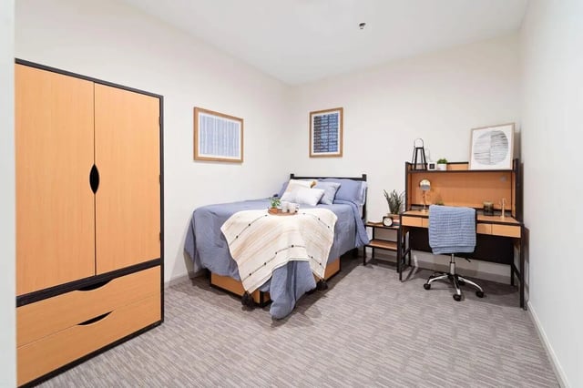 Wardrobe bed desk chair carpet bedroom at The Printing House in Binghamton Student Accommodation