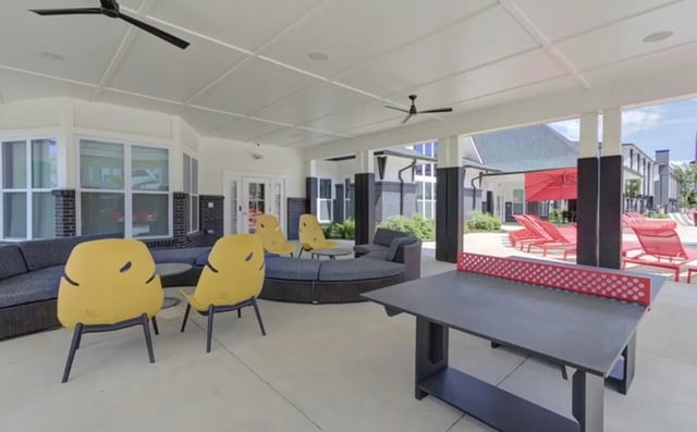 Ping pong table sectional sofa chairs lounge chairs outdoor area at The Row At The Stadium in Columbia Student Accommodation