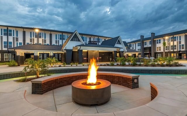 Fire pit and building exterior view at The Row At The Stadium in Columbia Student Accommodation