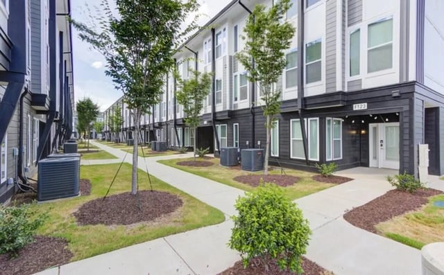 Exterior of modern townhouses with air conditioning units exterior at The Row At The Stadium in Columbia Student Accommodation