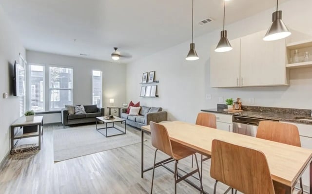 Sofa dining table kitchen cabinets living room kitchen at The Row At The Stadium in Columbia Student Accommodation