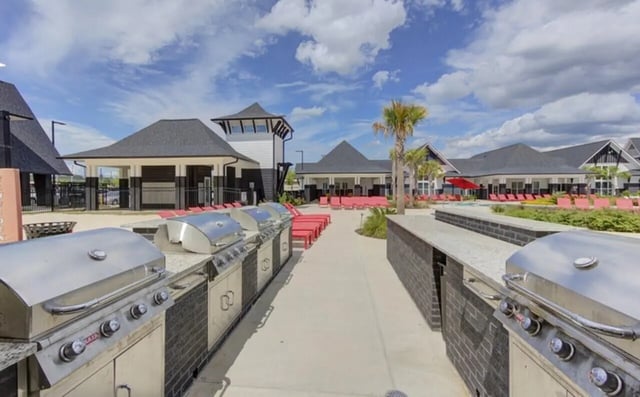 Grills lounge chairs and buildings outdoor communal area at The Row At The Stadium in Columbia Student Accommodation