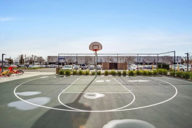 Basketball court with hoop and scooter playing area at The Crossings Apartments in Sacramento Student Accommodation