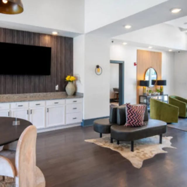 Modern seating area with TV and cabinets Living Room at Bellamy Daytona in Daytona Beach Student Accommodation