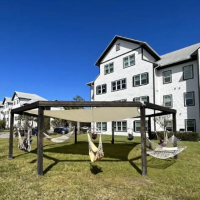 Hammock area with pergoda and apartment buildings exterior at Bellamy Daytona in Daytona Beach Student Accommodation