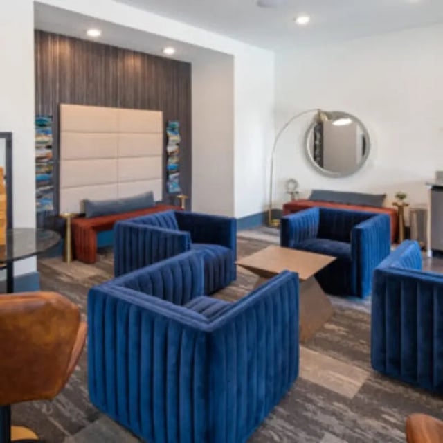 Blue velvet chairs and coffee table living room at Bellamy Daytona in Daytona Beach Student Accommodation
