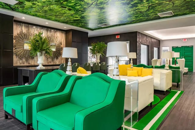 Green couches white sofas yellow cushions living room at The Ivy in Tampa Student Accommodation