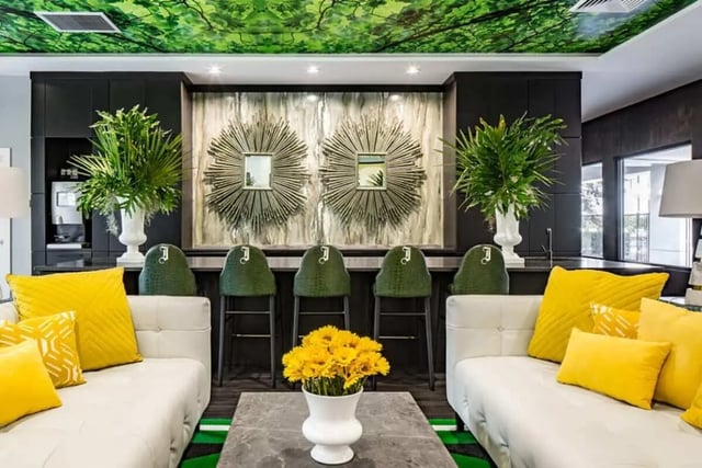 White couches green barstools sunburst mirrors living room at The Ivy in Tampa Student Accommodation