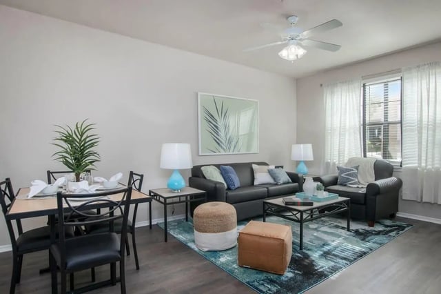 Dining table sofa chair ottoman living room at The Ivy in Tampa Student Accommodation