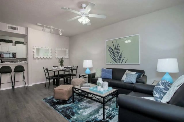 Sofa coffee table rug chairs lamps artwork living room at The Ivy in Tampa Student Accommodation