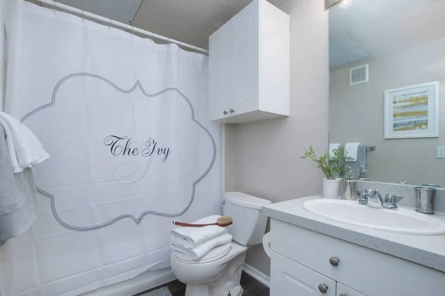 White shower curtain toilet sink cabinet bathroom at The Ivy in Tampa Student Accommodation
