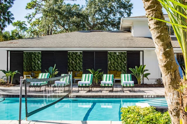 Poolside loungers with green striped cushions exterior at The Ivy in Tampa Student Accommodation