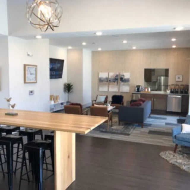 Long table black stools lounge seating kitchen living area at Bellamy Florence in Florence Student Accommodation