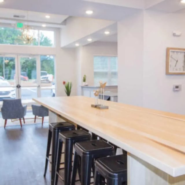 Long table with bar stools and seating area. at Bellamy Florence in Florence Student Accommodation