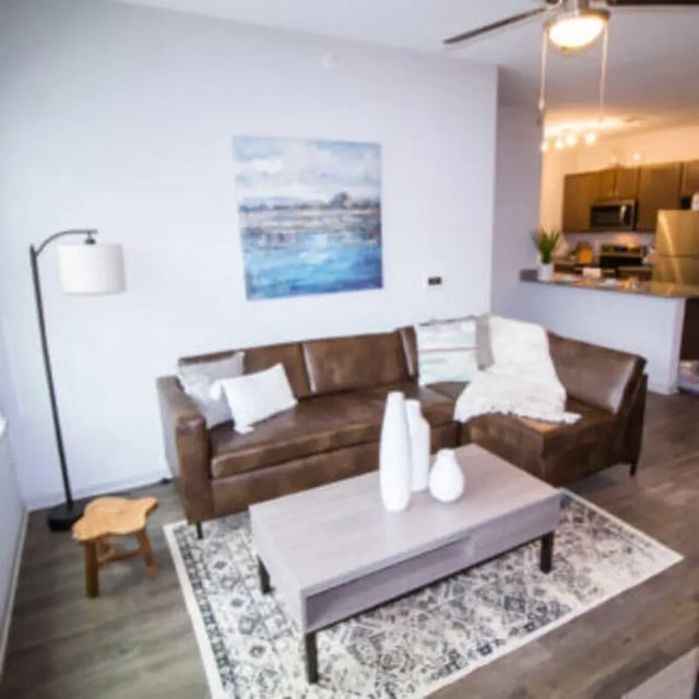 Brown sectional sofa coffee table art living room at Bellamy Florence in Florence Student Accommodation