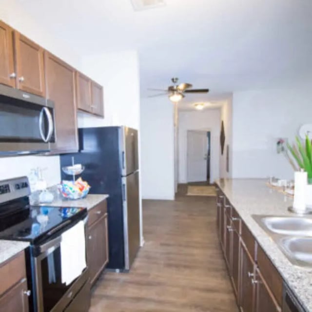 Kitchen with cabinets refrigerator stove and sink kitchen at Bellamy Florence in Florence Student Accommodation
