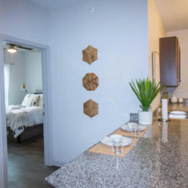 Bed with decorations and kitchen counter kitchen area at Bellamy Florence in Florence Student Accommodation