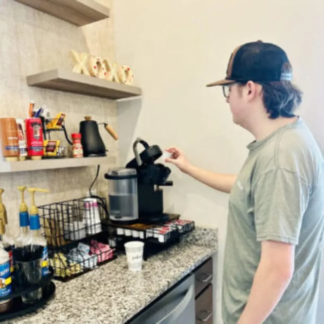 Person making coffee at coffee station kitchen at Bellamy Florence in Florence Student Accommodation