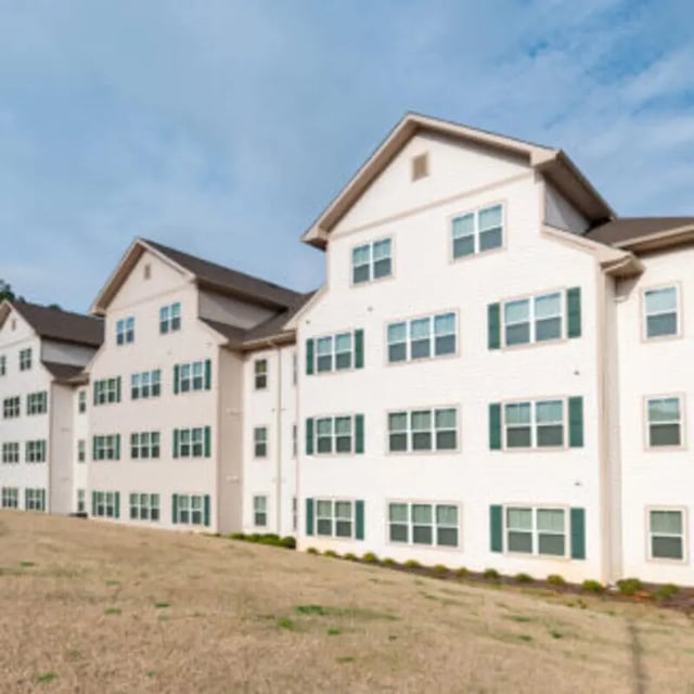 Apartment building with white siding and green shutters exterior at Bellamy Florence in Florence Student Accommodation