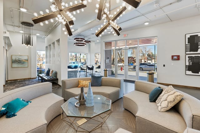 Curved couches hexagonal table abstract art modern chandeliers lounge area at Canyon Flats in Reno Student Accommodation