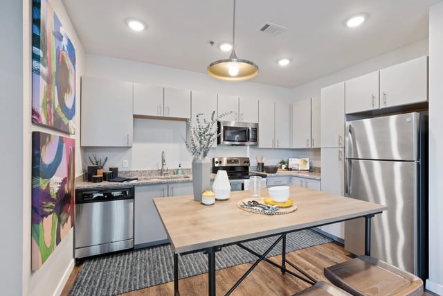 Modern kitchen with dining table refrigerator and art kitchen at Canyon Flats in Reno Student Accommodation