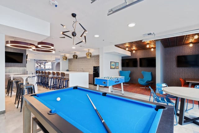 Pool table foosball blue chairs lounge area at Canyon Flats in Reno Student Accommodation