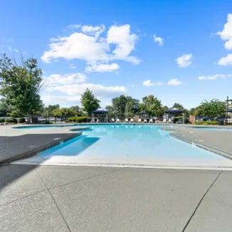 Pool area with lounge chairs and trees exterior at Bellamy Milledgeville in Milledgeville Student Accommodation