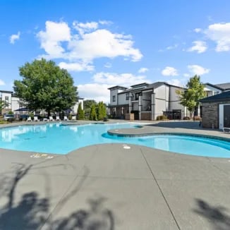 Large swimming pool with lounge chairs exterior at Bellamy Milledgeville in Milledgeville Student Accommodation