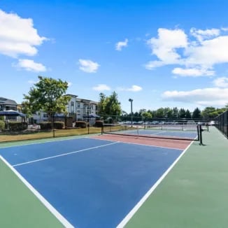 Two blue and green tennis courts exterior at Bellamy Milledgeville in Milledgeville Student Accommodation