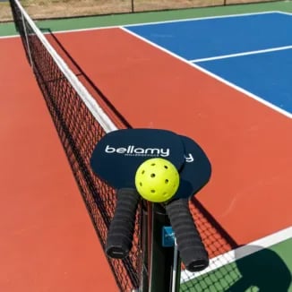 Pickleball paddles and ball on court playing area at Bellamy Milledgeville in Milledgeville Student Accommodation