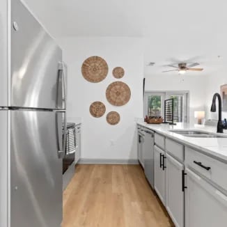 Stainless fridge modern cabinets quartz countertop kitchen at Bellamy Milledgeville in Milledgeville Student Accommodation