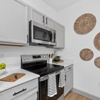 Modern grey kitchen with microwave stove and decor kitchen at Bellamy Milledgeville in Milledgeville Student Accommodation